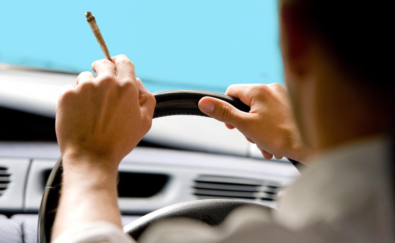 man smoking a joint while driving 0